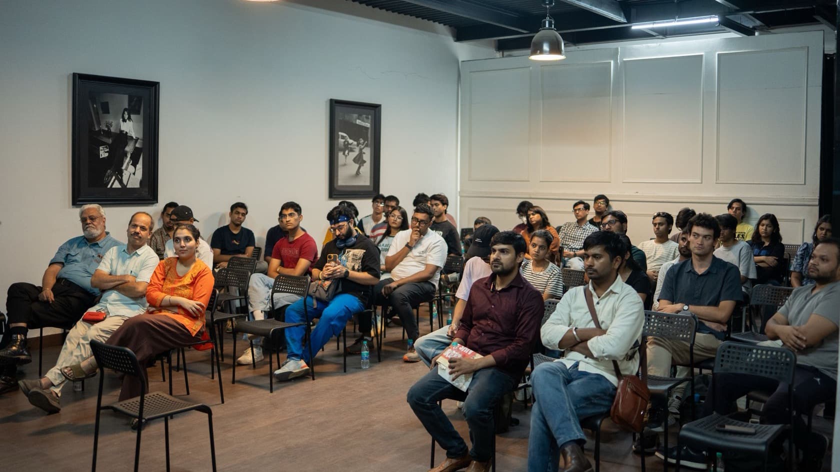 Delegates seated in rows listening at an indoor seminar session in India