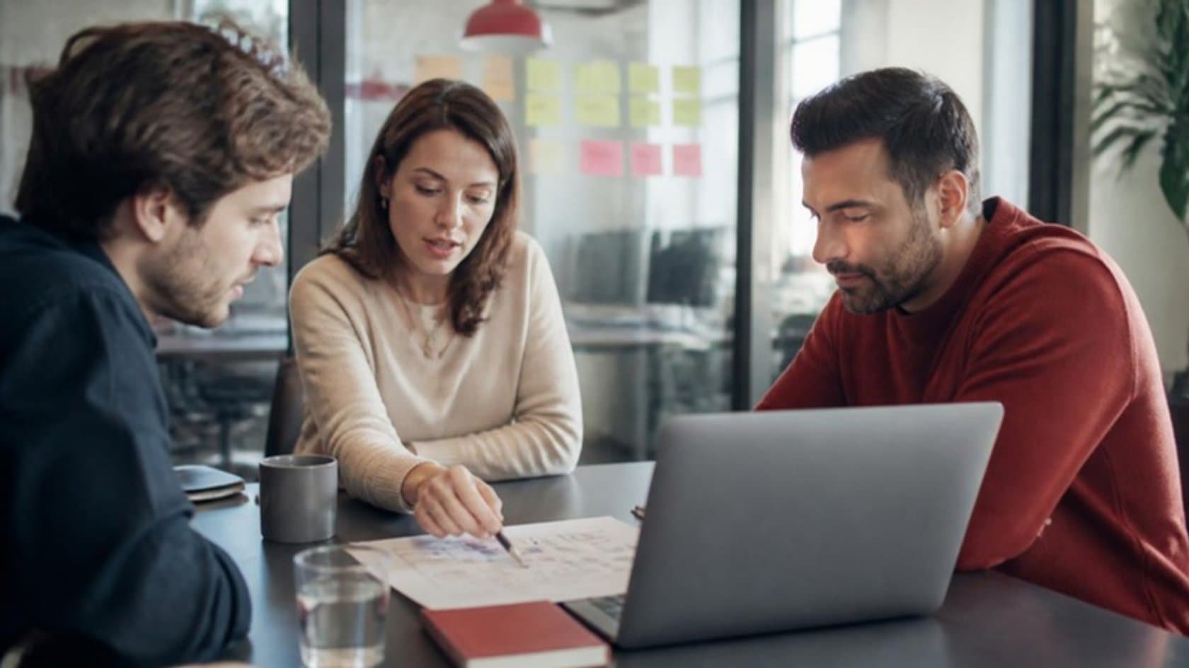 Small team planning an AI pilot project around a one-page brief and a laptop
