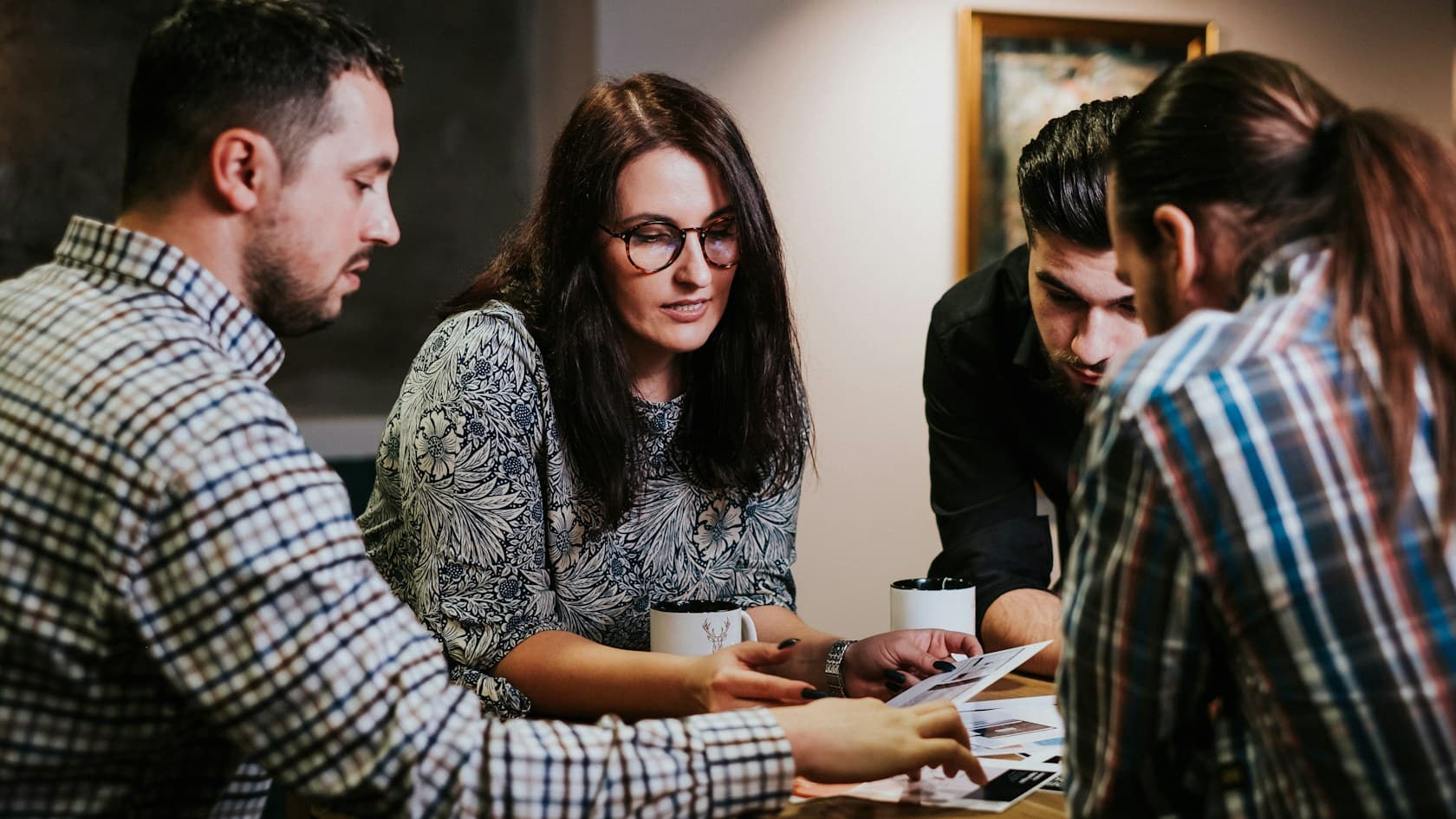 Operations team reviewing printed documents together at a table