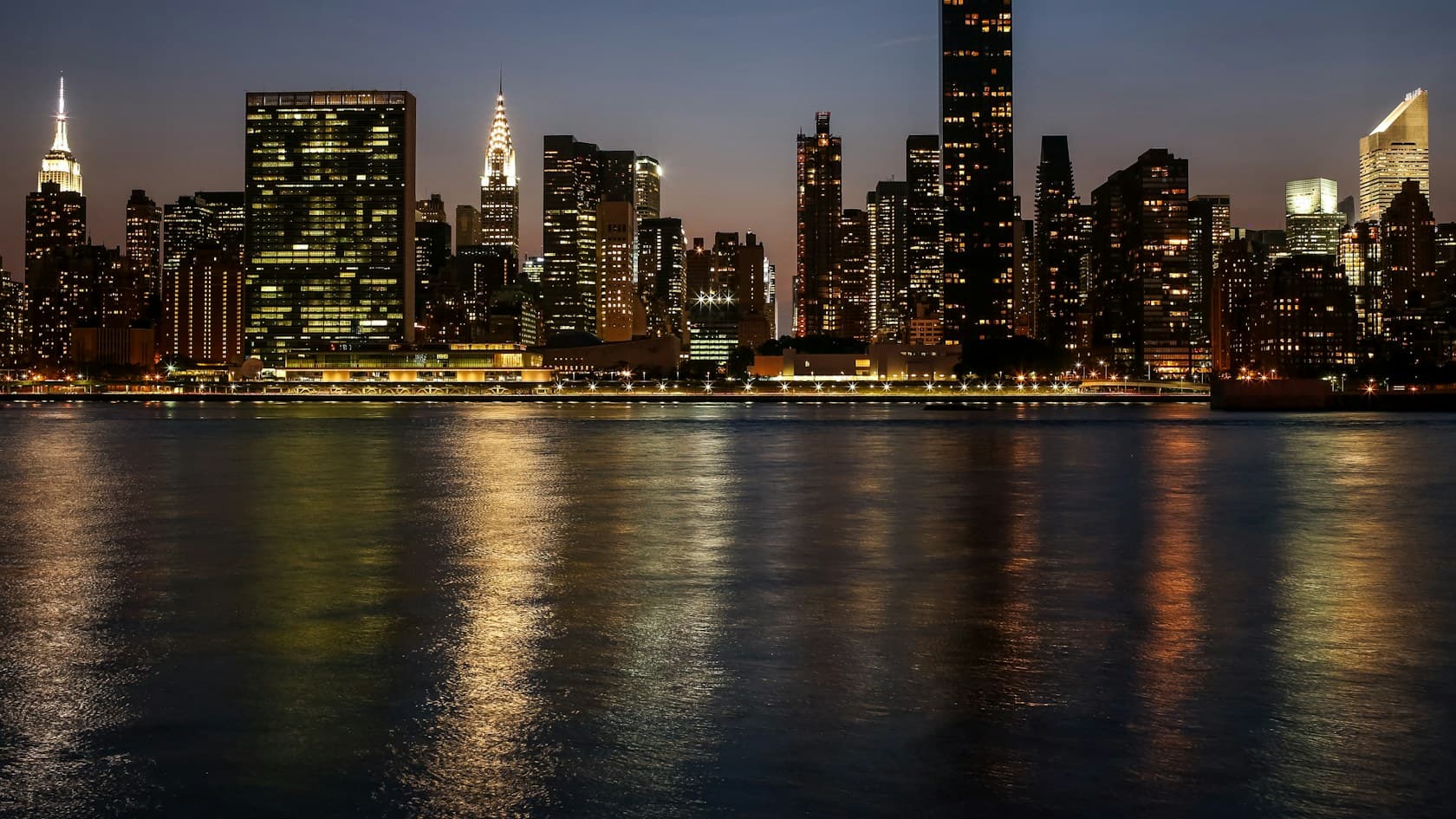 City skyline lit up at night across the water