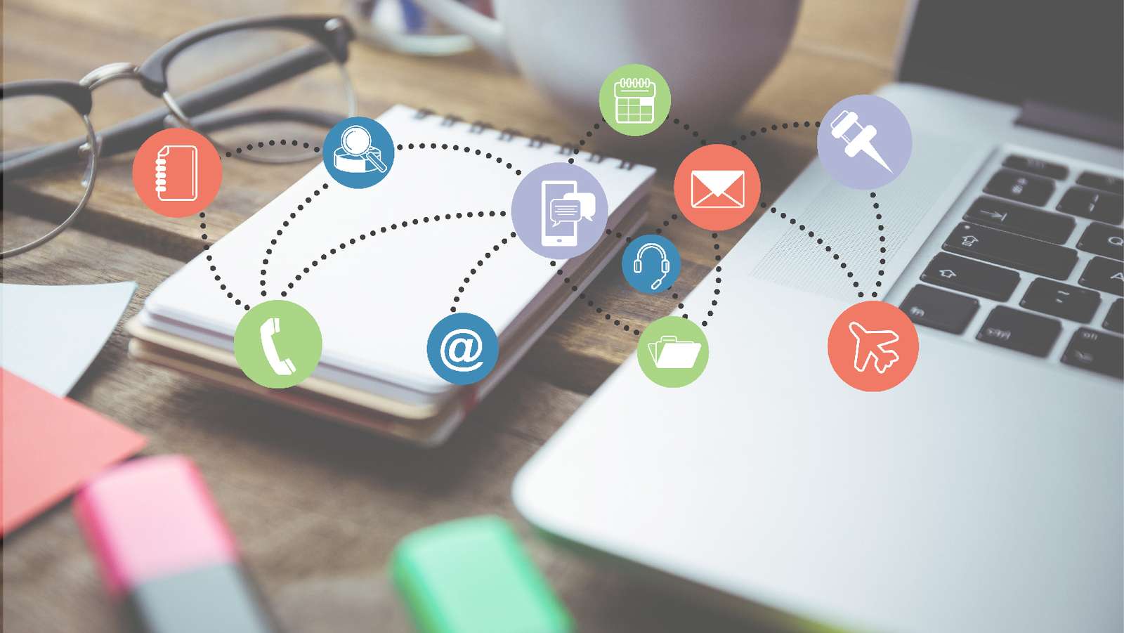 Notebook and laptop on a desk overlaid with connected icons for calls, email, calendar and files